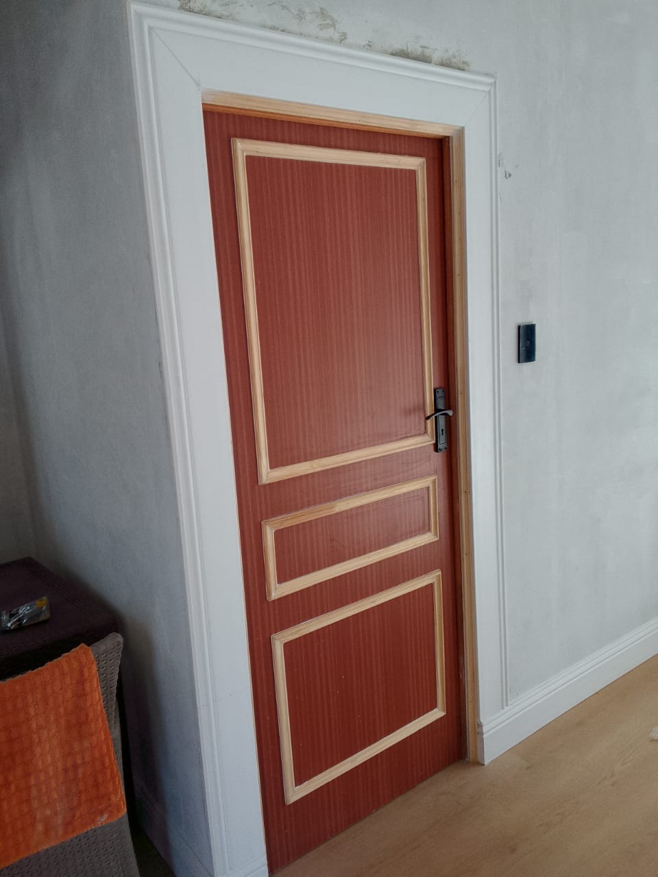 Custom interior door installation Port Elizabeth — rich red mahogany 3-panel door with pine trim and white decorative architrave